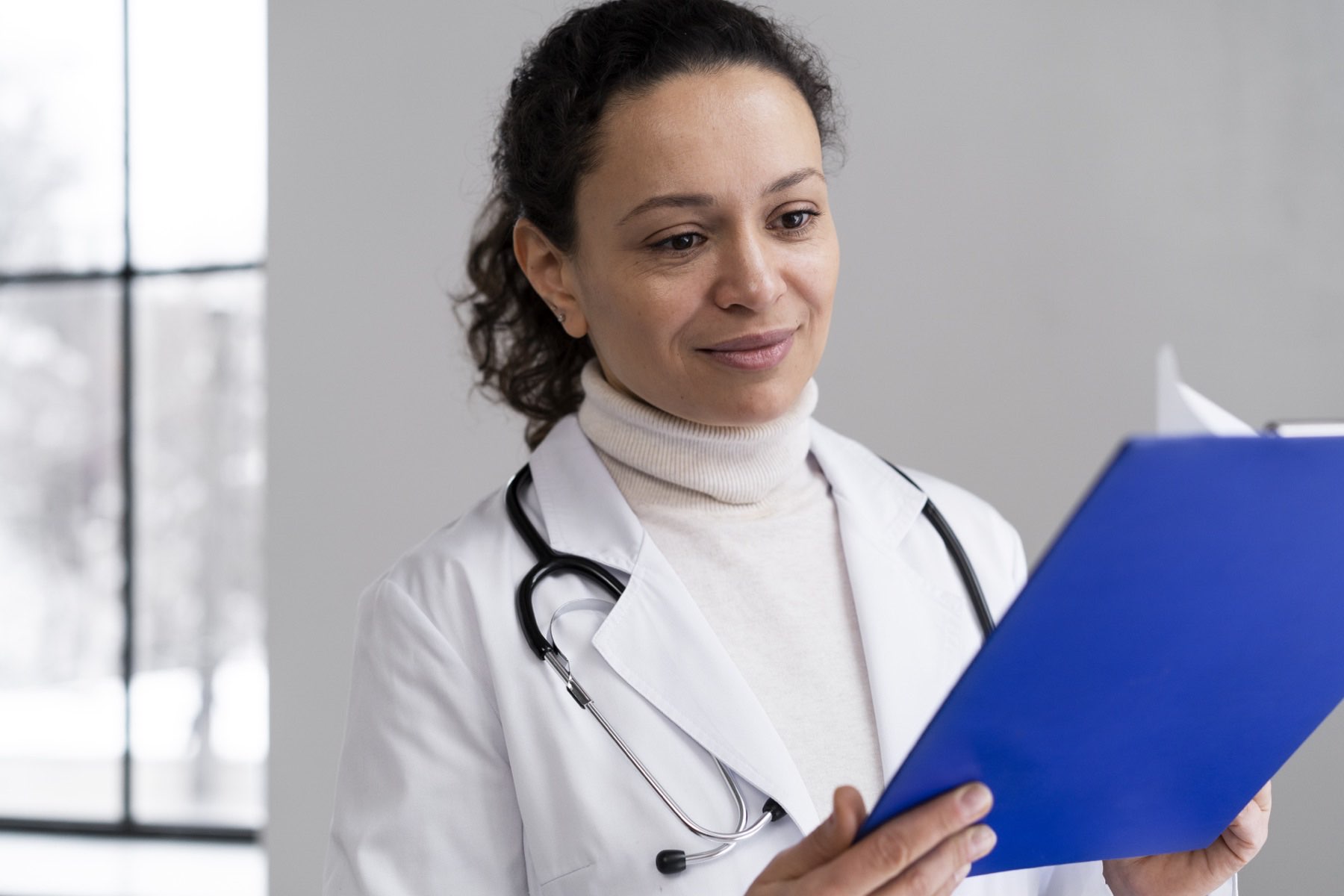 A practice owner in their clinic reviewing the month's numbers.